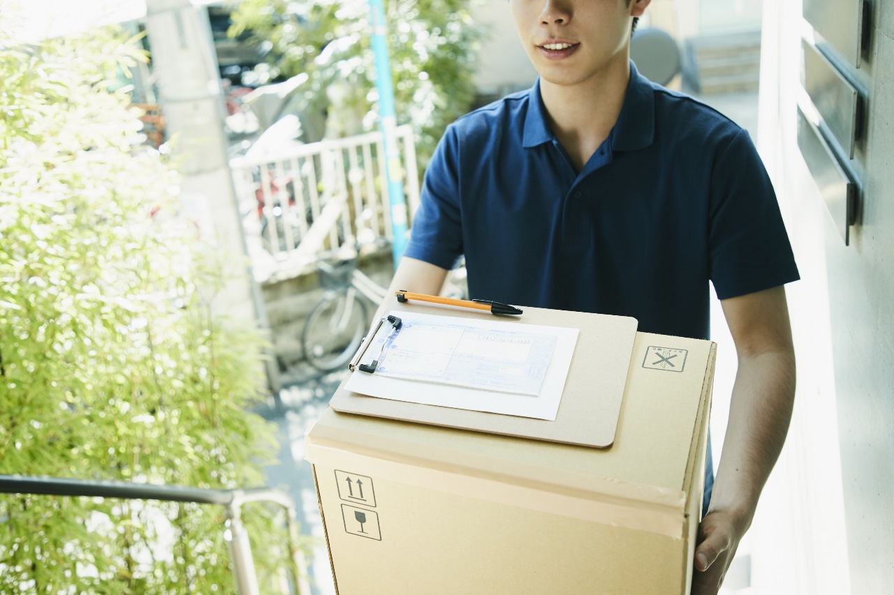 Delivery guy arriving with package from ecommerce in Japan