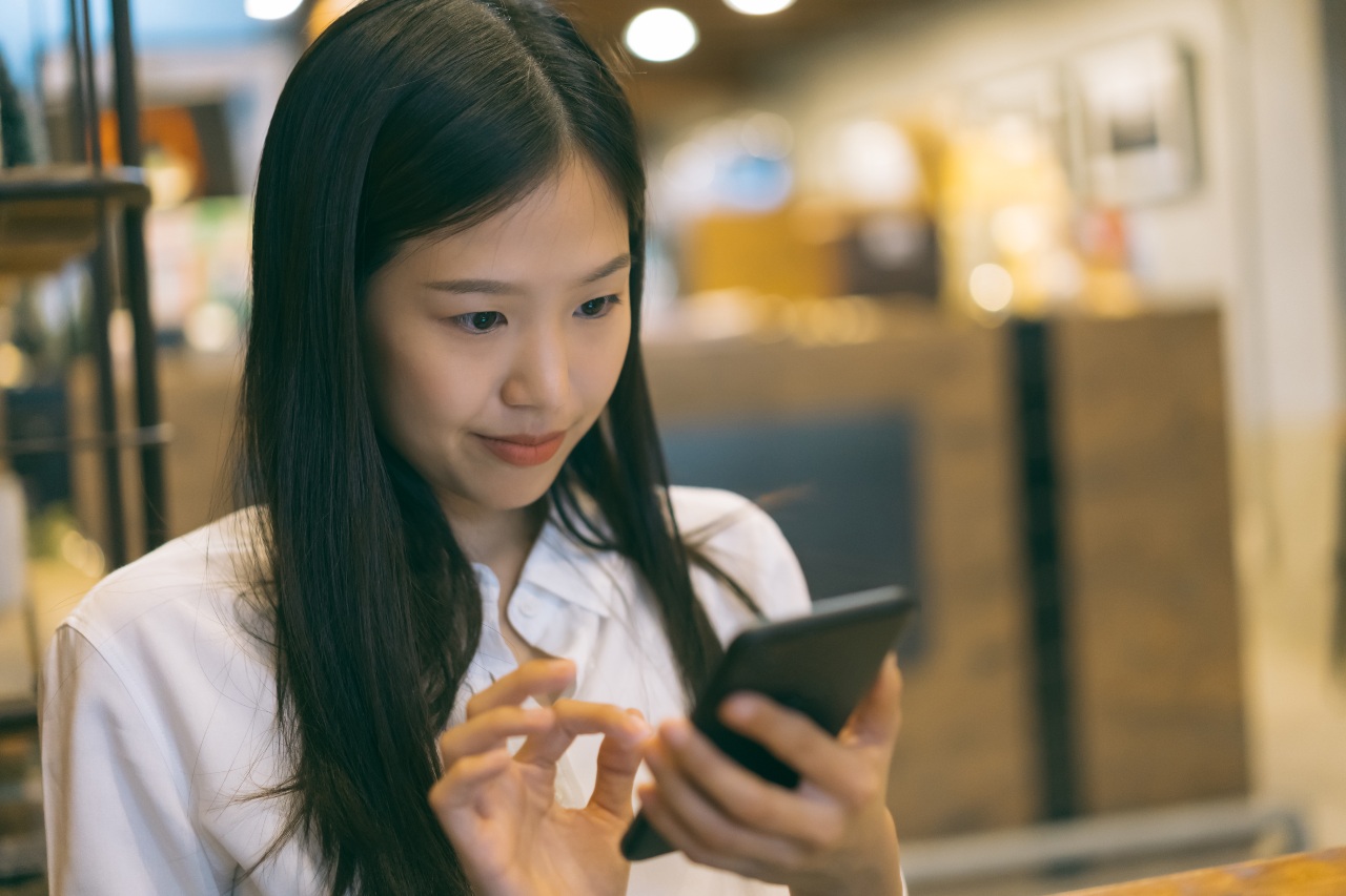 Woman communicating with LINE friend and browsing LINE advertising in Japan