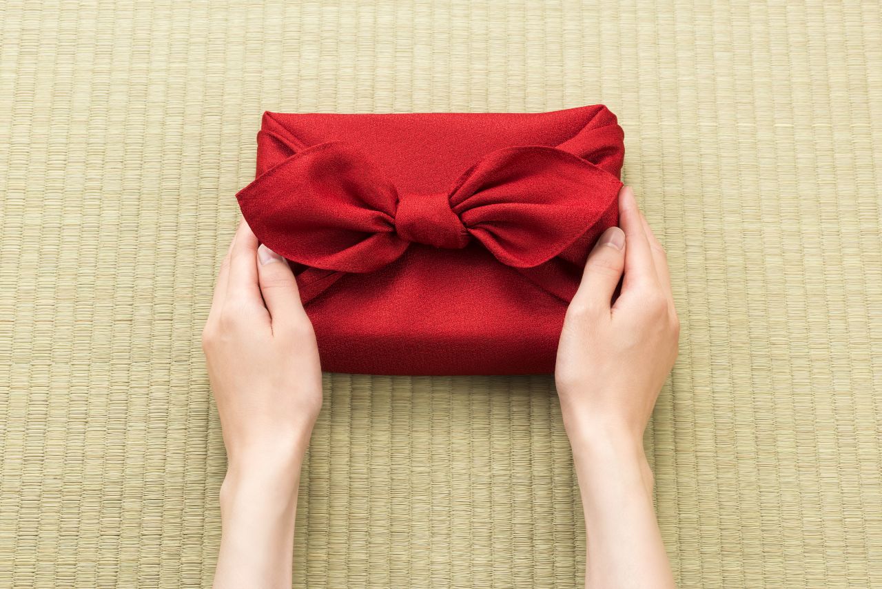 Woman giving gift during Japanese holidays bought from ecommerce in Japan