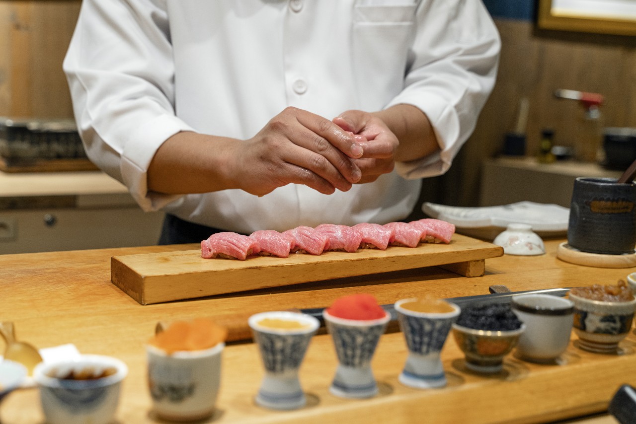Chef at Japanese sushi bar representing barriers to sustainability in Japan