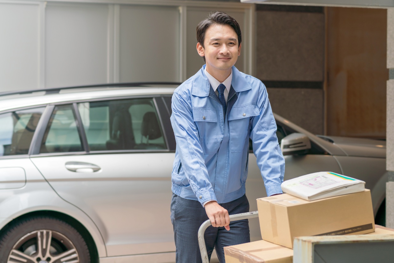 Ecommerce in Japan delivery worker moving packages after transport