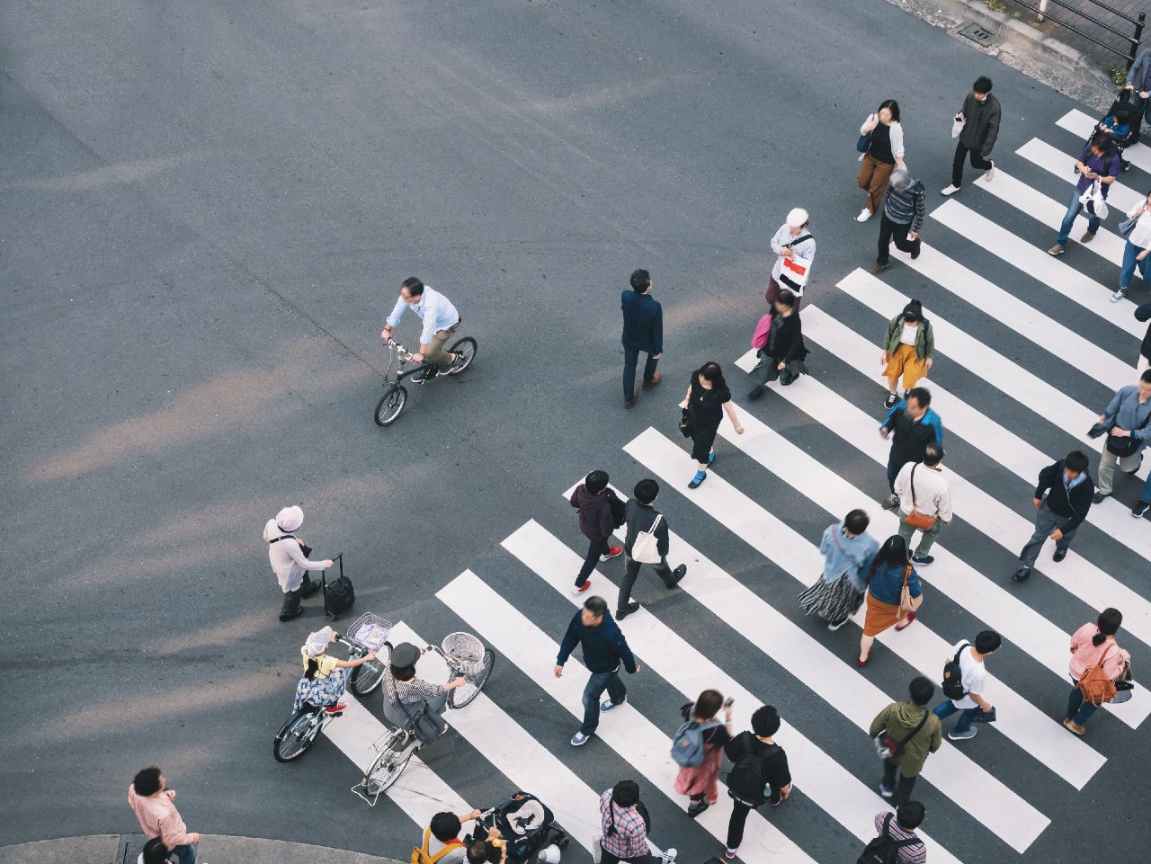 Japanese people crossing the road representing different demographics using social media