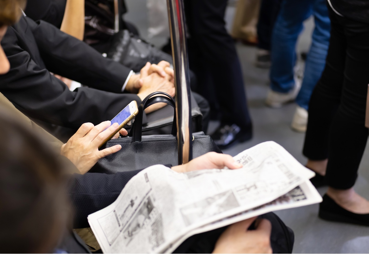 Man on train reviewing content published by PR agencies in Japan