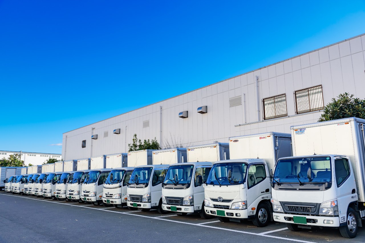 A row of delivery trucks waiting to support ecommerce logistics in Japan