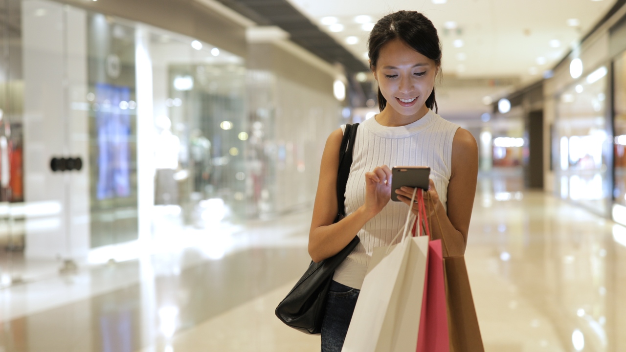 Tech savvy shopper using mobile ecommerce in Japan while shopping